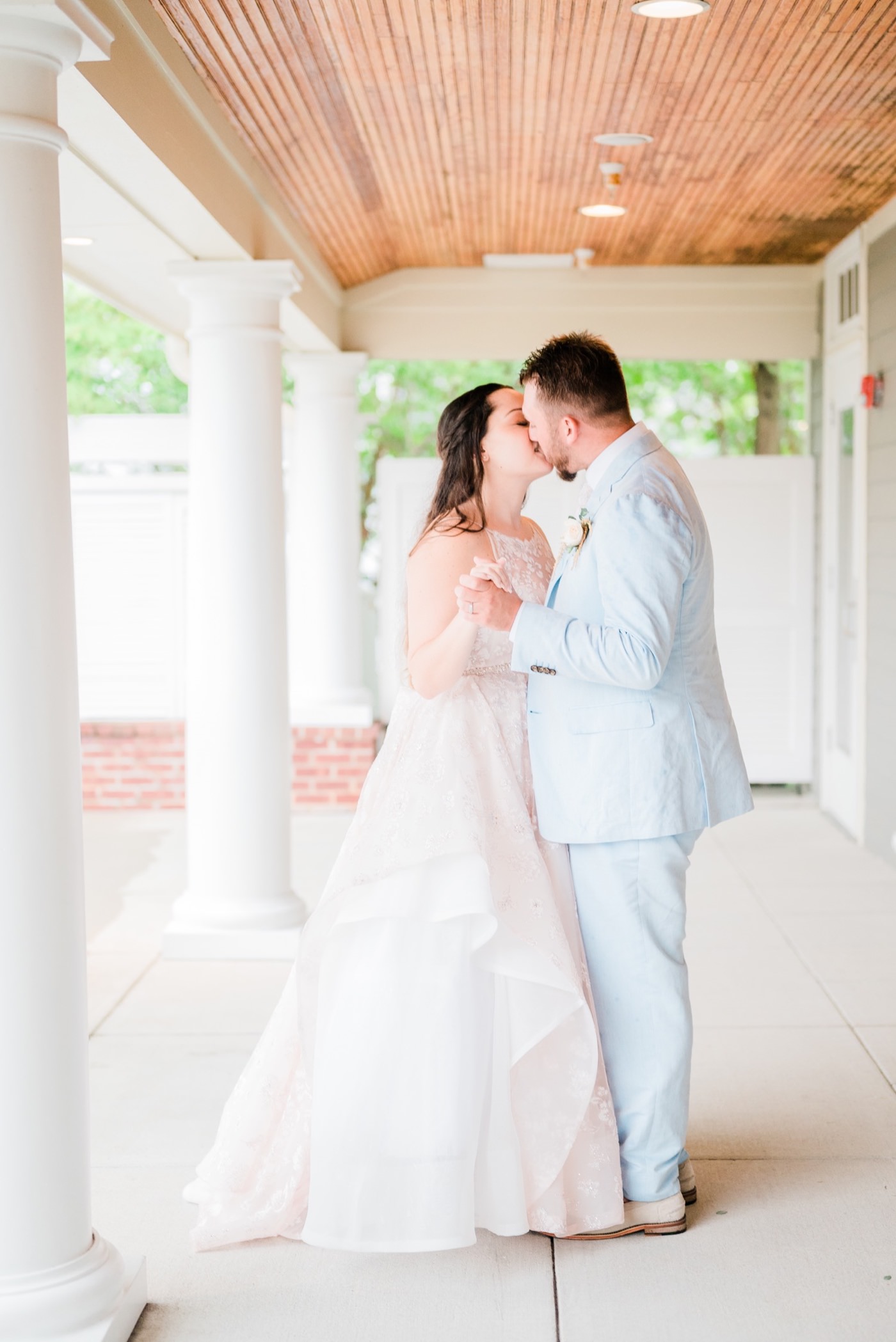 Chesapeake Bay Beach Club Wedding photos, bride and groom dance under porch, CBBC, Rainy wedding inspiration