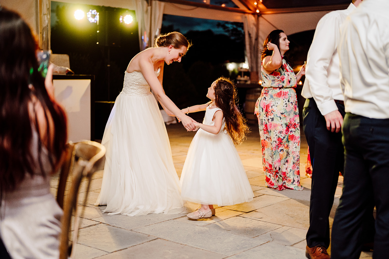 Bride dances with flower girl at Market at Grelen wedding reception