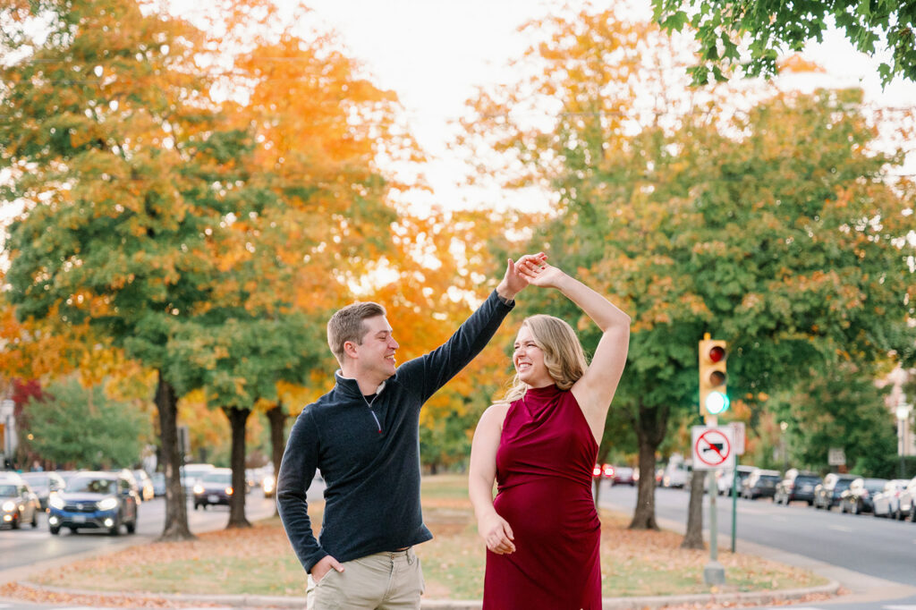 Couple laughing and dancing on the downtown Richmond streets during their engagement photos