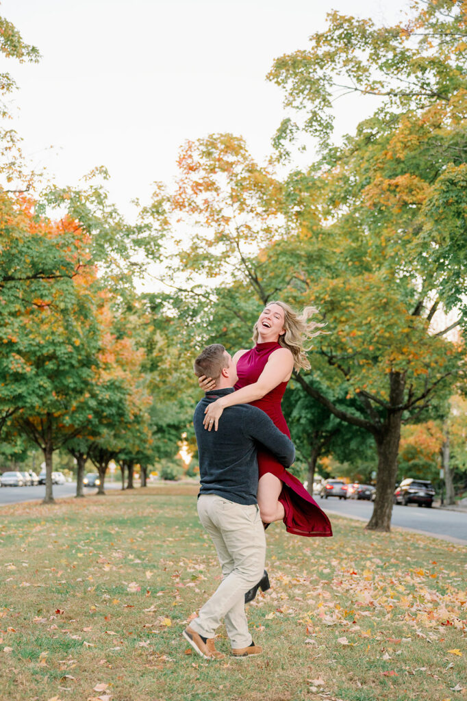 Engaged couple spinning and in love on Monument Ave